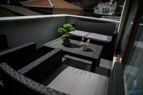 a small table and chairs on a balcony at Platine Istiklal Suite in Istanbul