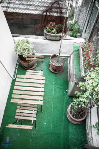 a patio with chairs and potted plants on a balcony at Platine Istiklal Suite in Istanbul