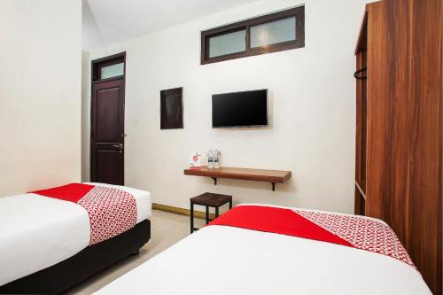 Postel nebo postele na pokoji v ubytování Hotel O Genteng Near Genteng Market Formerly Uno Hotel