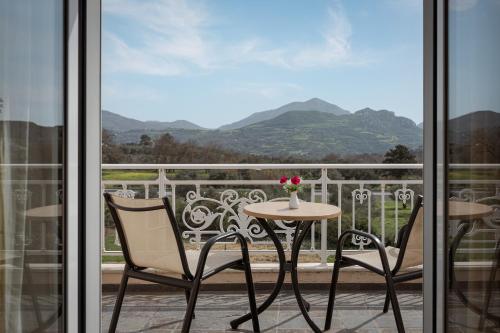 a table and two chairs on a balcony with a view at Villa Aurora Crete in Koxaré