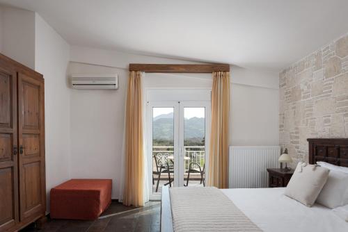 a hotel room with a bed and a balcony at Villa Aurora Crete in Koxaré