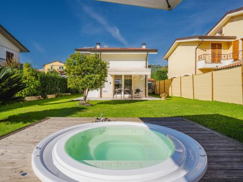 a hot tub in the backyard of a house at Holiday Home La Frida 2 by Interhome in Stiava