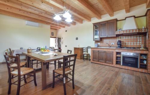 a kitchen with a table and chairs in a room at Gorgeous Home In Motta Camastra in Motta Camastra