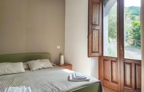a bedroom with a bed and an open window at Gorgeous Home In Motta Camastra in Motta Camastra