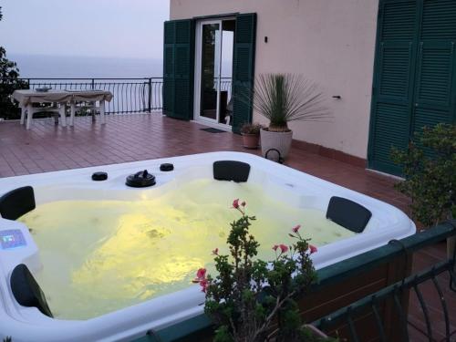 a jacuzzi tub on the balcony of a house at Holiday Home Casa Cycas by Interhome in Ospedaletti