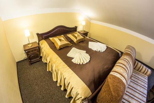 a bedroom with a large bed with two pillows at Penzión Altmayer in Banská Štiavnica