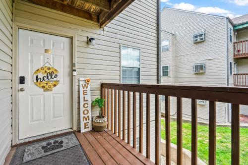 a home with a white door and a deck at Family and Pet friendly ground level Condo, 4 mins to Silver Dollar City, Amazing Ozark Mountain Views in Branson