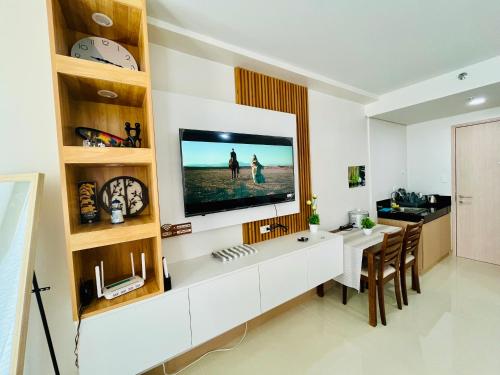 a living room with a television on a wall at MyHome Condo with Balcony in Iloilo City