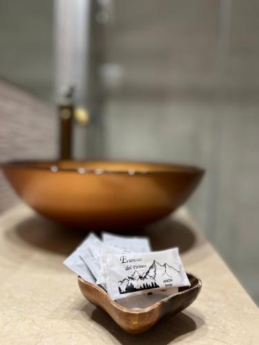 a wooden bowl sitting on a counter next to a plate at Fonda Carrera in Labuerda