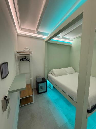 a small bedroom with a bed and a tv at iRooms - Spanish Steps in Rome