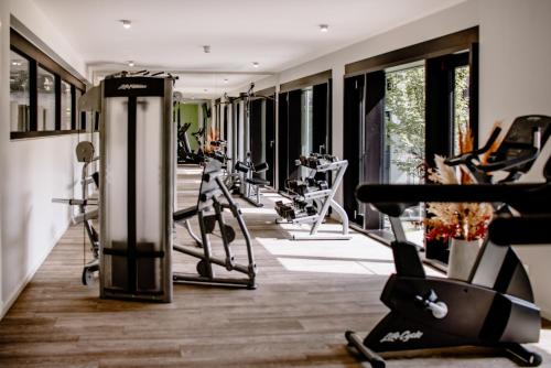 a gym with treadmills and cardio equipment in a room at THE FLAG München M. in Munich