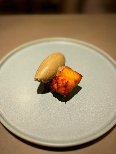 a piece of food sitting on a white plate at 白水温泉竹の倉山荘 in Minami Aso