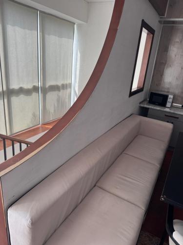 a white couch in a room with a window at Отдых у моря Одесса in Kryzhanivka