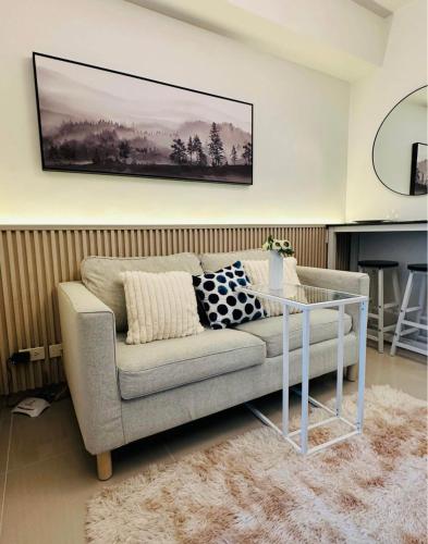 a living room with a couch and a table at Withusmile in Pampang