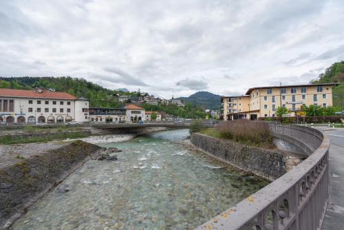 a bridge over a river in a town with buildings at Fewo Oberschönauer Bergblick in Schönau am Königssee
