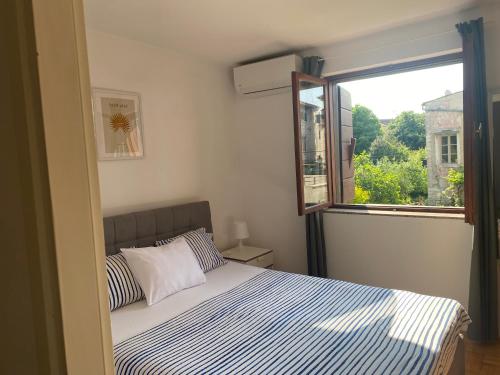 a bedroom with a bed and a window at Guest House Marta in Rovinj