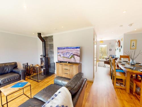 a living room with a couch and a table at Killiechangie House in Newtonmore