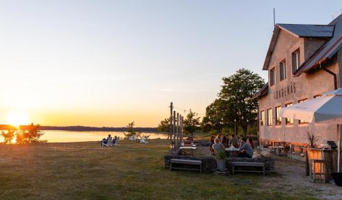 a group of people sitting on benches outside of a building at Bungenäs Badhotell in Fårösund