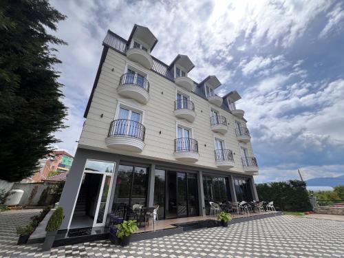a large building with windows and chairs at Mont Blanc Hotel in Peshkopi