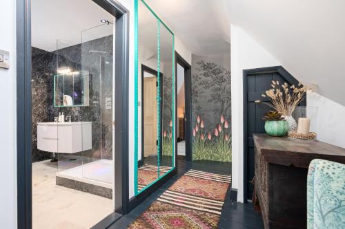 a bathroom with a shower and a sink and a mirror at Eskbank Terrace Spacious House in Dalkeith