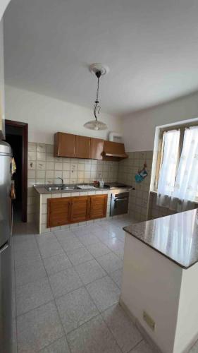a kitchen with wooden cabinets and a counter top at Villa Wanda in Anzio