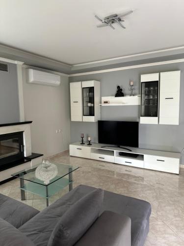 a living room with a couch and a tv at Eva House in Kanallaki