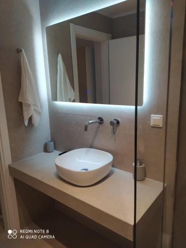 a bathroom with a sink and a mirror at Themonia Studios Kimolos in Kimolos