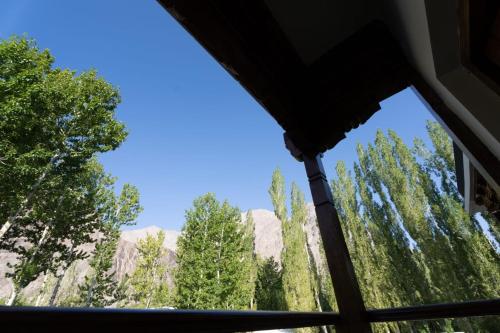 a view of the mountains from a room with a window at Summer-Retreat Nubra in Hundar