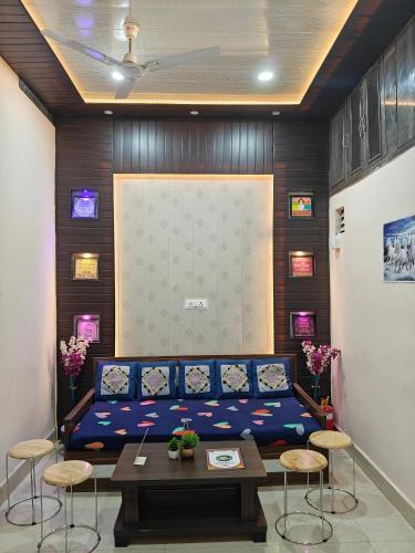a room with a couch and some chairs and a table at Anjani Home - 3Bhk Homely & GroundFloor Appartment for Families in Varanasi