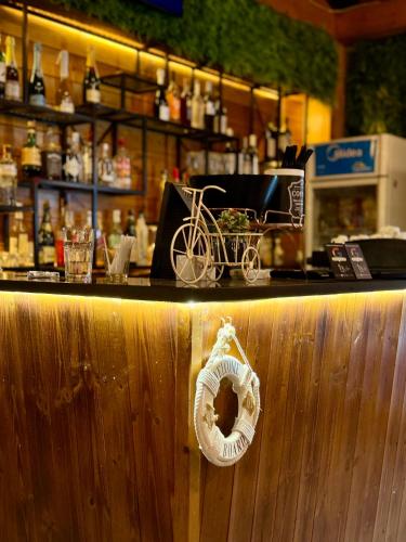 a bar with a counter with a bike on it at Kamberi Hotel & Apartments in Velipojë