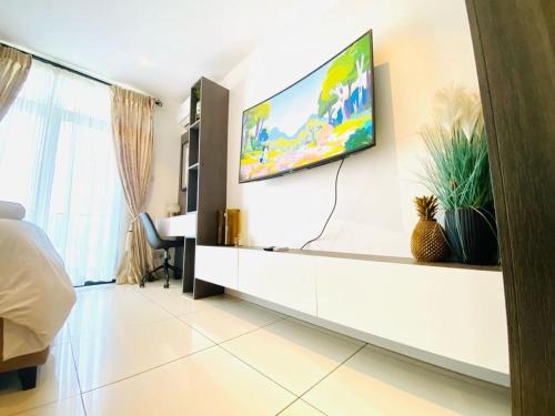 a bedroom with a flat screen tv on a wall at APARTMENTS GH - Accra - Cantonments - Embassy Gardens in Accra