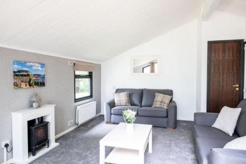 a living room with a couch and a fireplace at Barmouth Bay Holiday Park in Barmouth