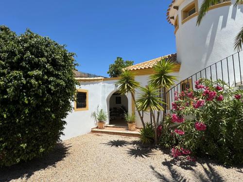 a white house with some plants and flowers at Casa Maravilla in Mazarrón