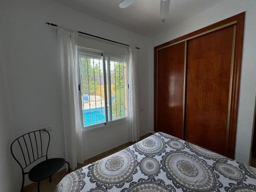 a bedroom with a bed and a window at Casa Maravilla in Mazarrón
