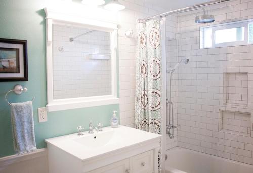 a bathroom with a white sink and a shower at Getaway Beach Bungalow - Kid and Pet Friendly in Carlsbad