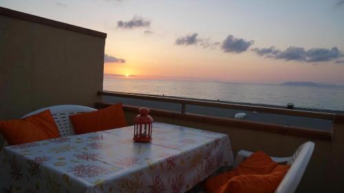 a table on a cruise ship with a view of the ocean at Terrazza Sul Mare in Terme Vigliatore