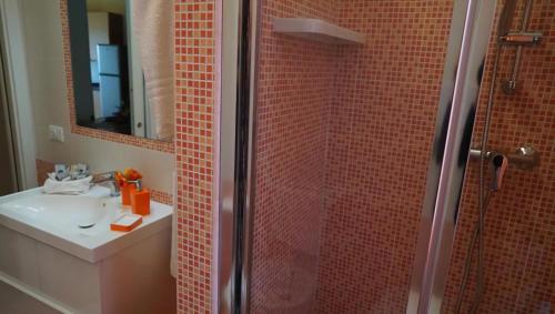a bathroom with a shower with a sink and a mirror at Terrazza Sul Mare in Terme Vigliatore