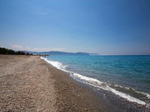 a beach with a rocky shore and the ocean at Terrazza Sul Mare in Terme Vigliatore