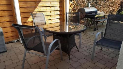 a table and chairs and a grill on a patio at Goorstorf in Bentwisch