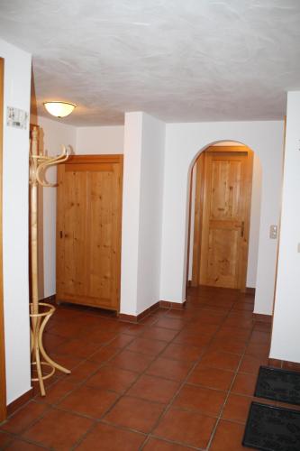 a hallway with two doors and a tile floor at Ruhige Wohnung Im Ortszentrum in Sankt Gallenkirch