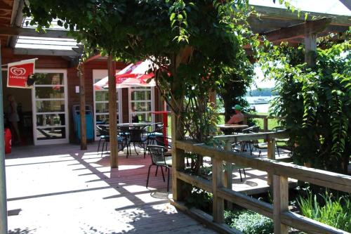 a patio of a restaurant with tables and chairs at Mobilheim Lagune I In Lychen in Lychen