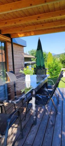 a patio with a table and chairs on a deck at Ferienhaus Sonneninsel In Velden Am Wörthersee in Velden am Wörthersee