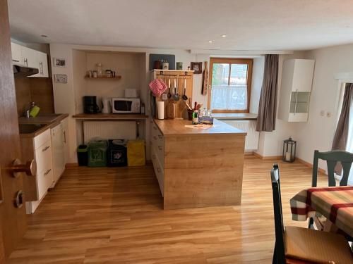 a kitchen with a island in the middle of a room at Fewo Edelweiss in Nesselwängle