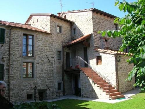 a large brick building with stairs in front of it at La Corte in Pratovecchio