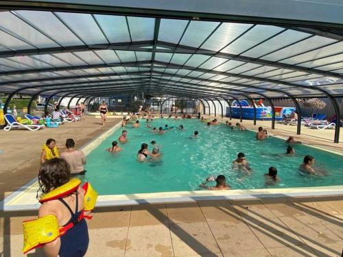 un groupe de personnes dans une piscine dans l'établissement Cabane 3 étoiles - Piscine - eeedda, à Guérande
