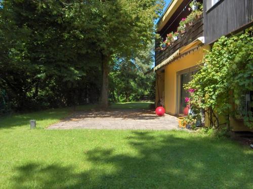 un patio trasero de una casa con un patio con césped verde en Appartement In Ruhbank Mit Garten Und Terrasse, en Pirmasens