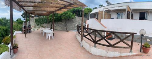 a patio with a table and chairs and a building at Villa Antonio in Ischia