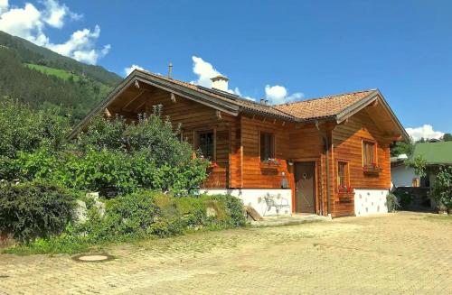 a wooden house with a driveway in front of it at Ferienhaus Haus Barbara In Aschau Im Zillertal in Aschau