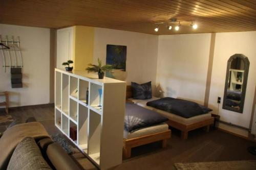 a room with two beds and a book shelf at Ferienwohnung Loni In Viereth in Viereth