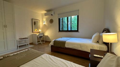 a hotel room with two beds and a window at Golfinho - Private Pool - 10 Guests - Albufeira in Albufeira